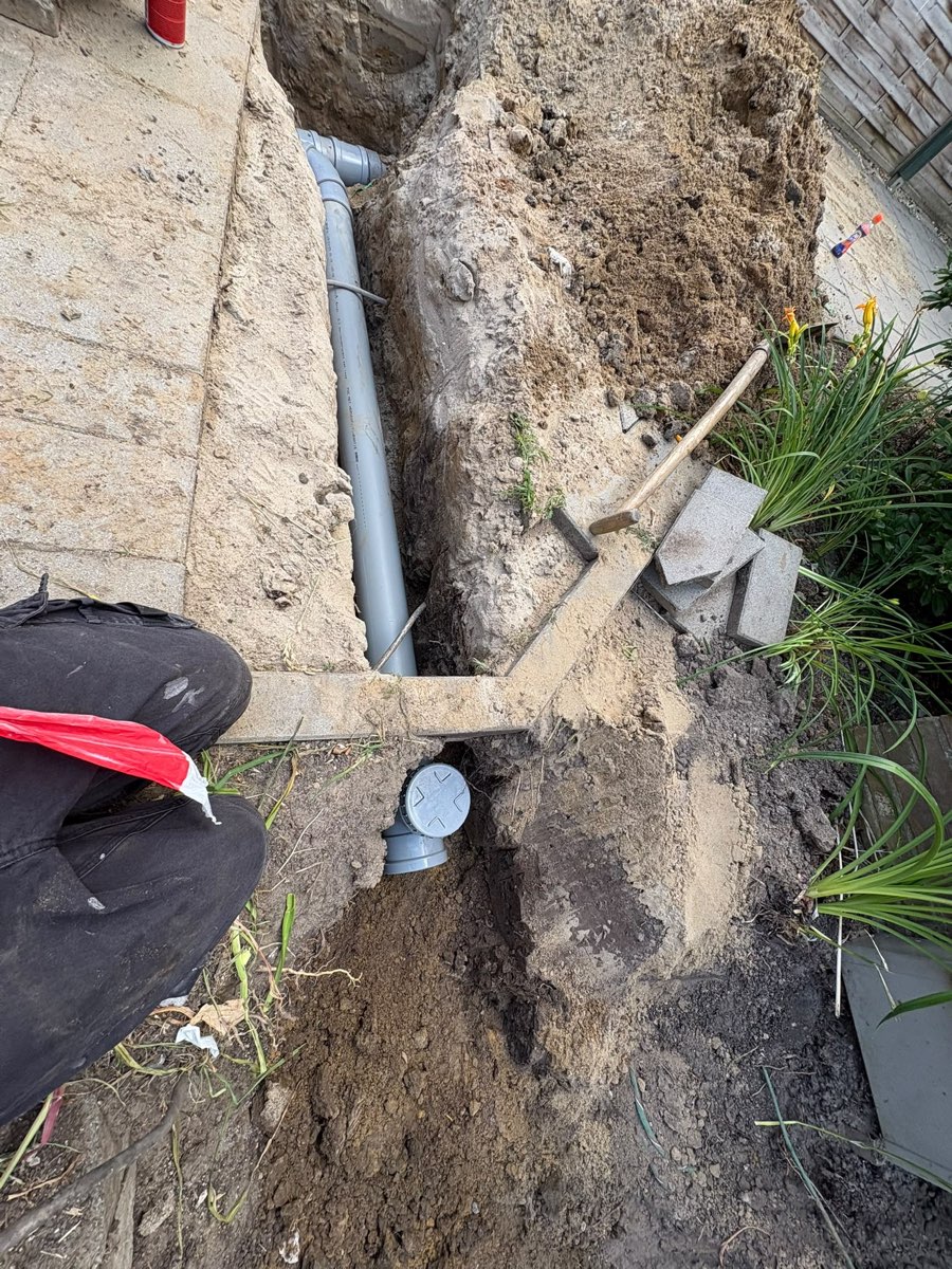 Nieuwe rioolleiding met ontstoppingsstuk in de tuin